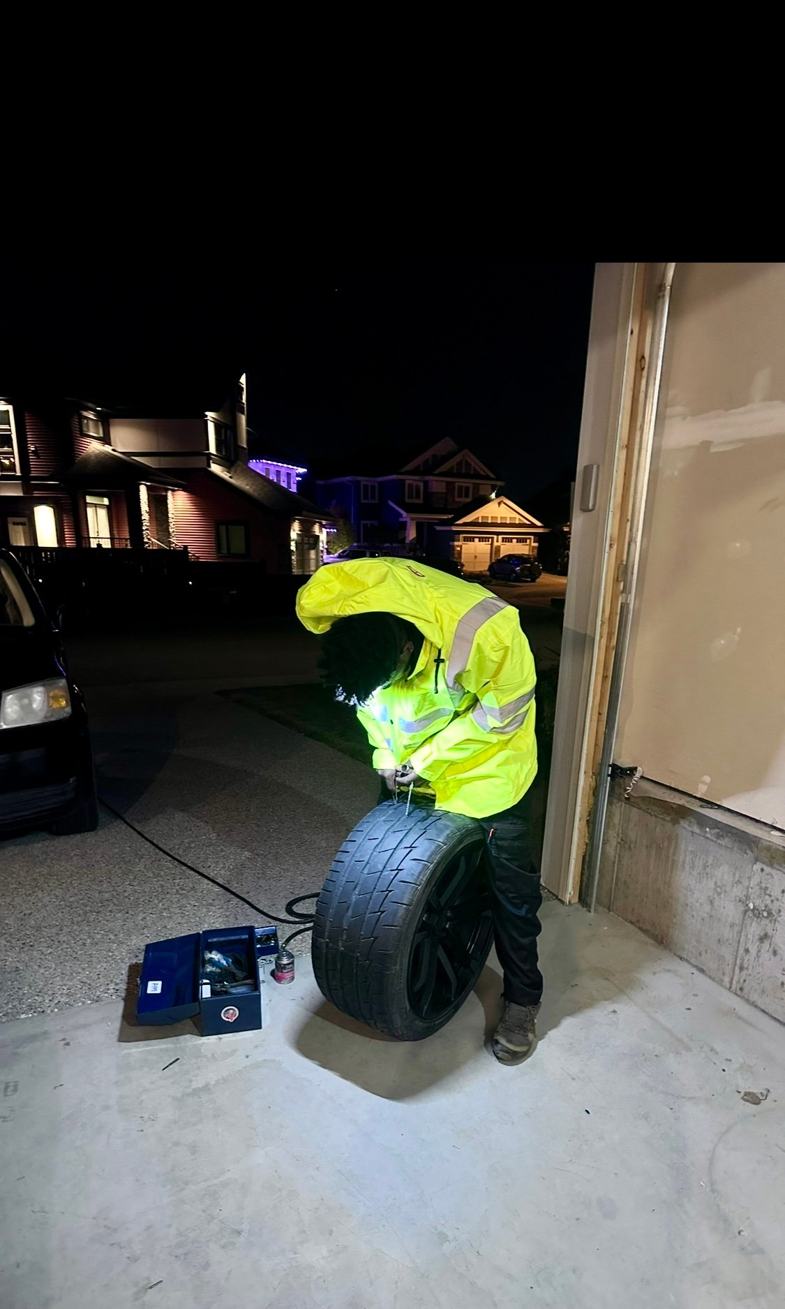 Night-time tire repair at a customer driveway in Edmonton