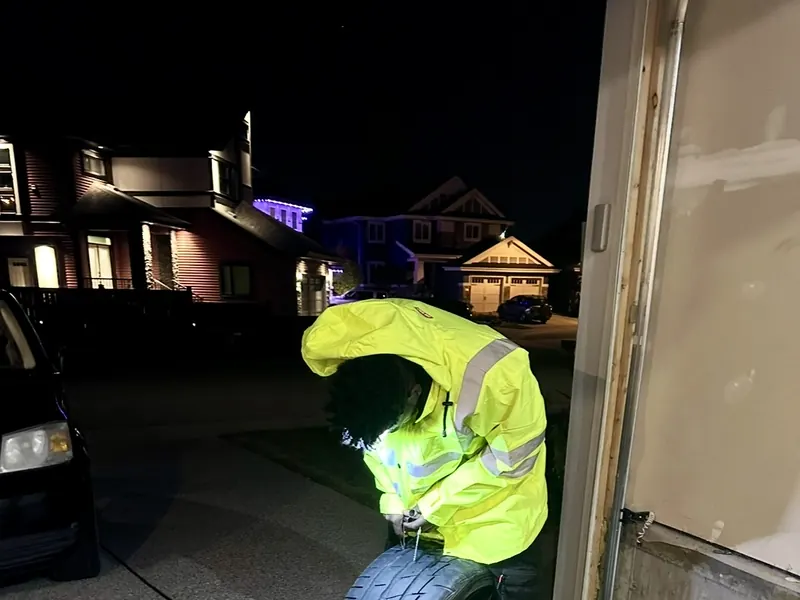 Night-time tire repair at a customer driveway in Edmonton
