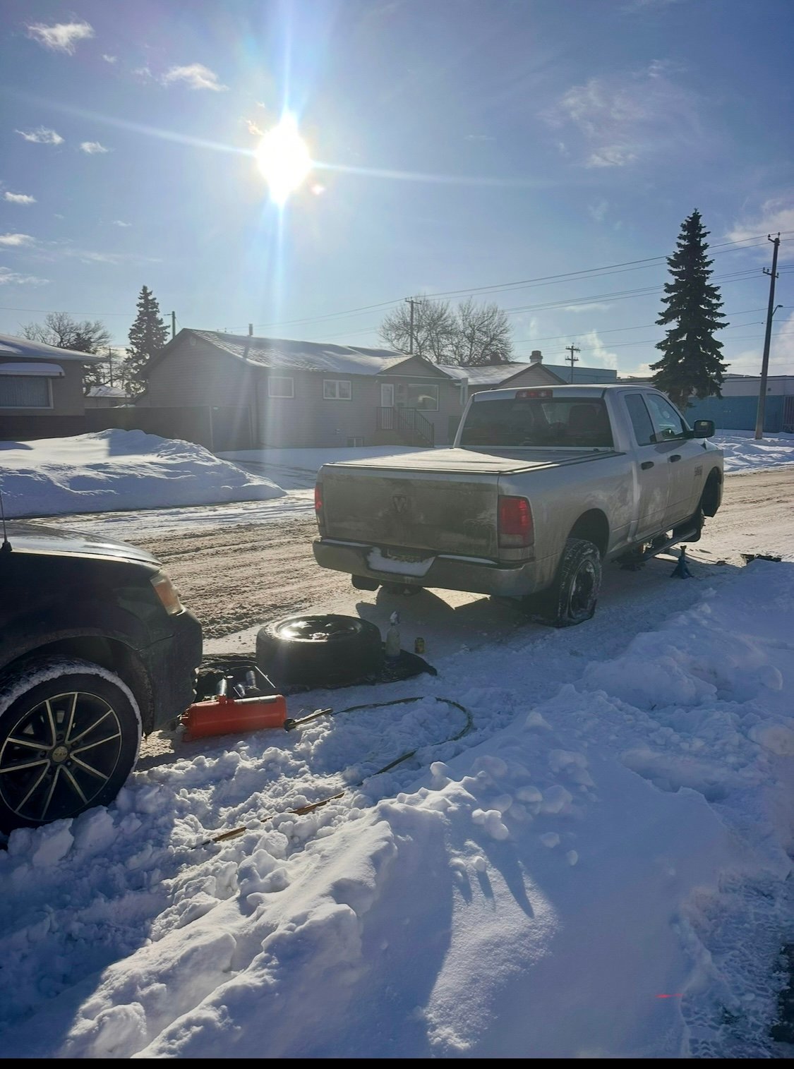 Shakur Roadside tire service on a Ram truck in snowy Edmonton