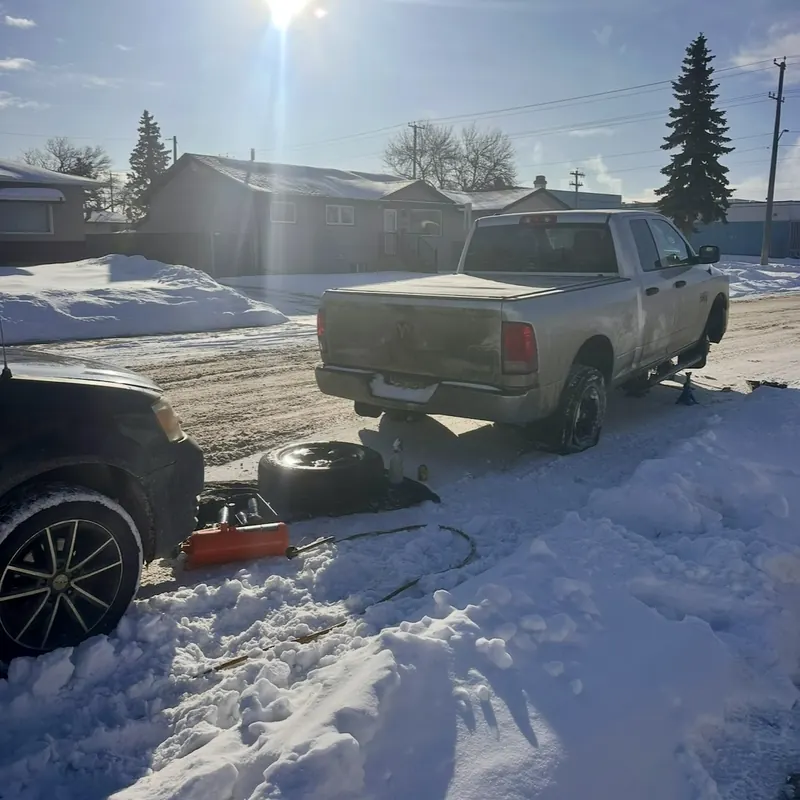 Shakur Roadside tire service on a Ram truck in snowy Edmonton