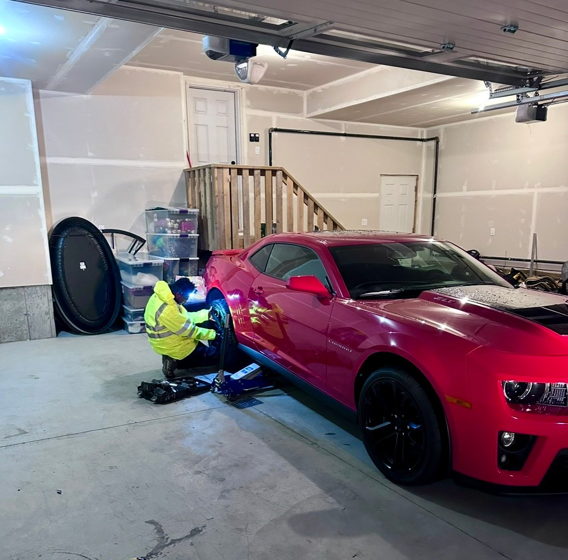 Shakur Roadside technician changing a tire on-site in Edmonton