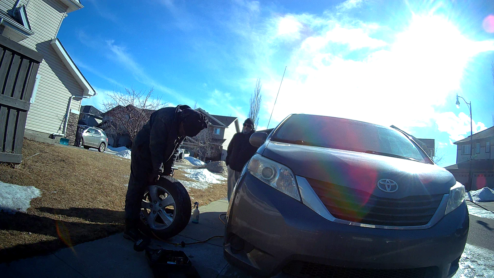 Shakur Roadside technician repairing a flat tire on-site in Edmonton